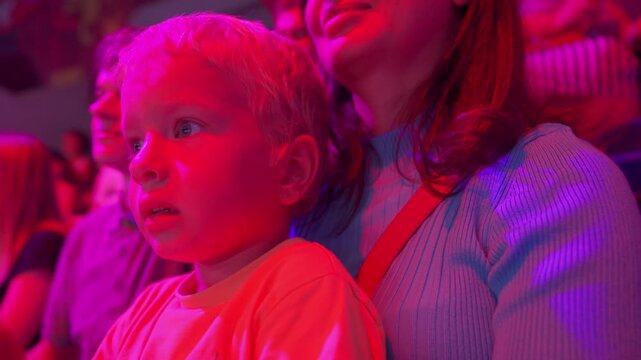 Spectators in a circus. Happy family with small child watching a circus performance. Little boy at circus. Simferopol, Crimea, Russia 2024