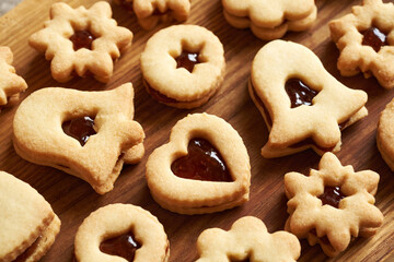 Heart, star and bell shaped Linzer Christmas cookies filled with marmalade