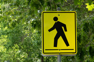 Pedestrian crosswalk warning sign pointing left