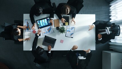 Top view of smart manager give vr head set to businesspeople while businesswoman prepare data analysis or analytic graph in laptop at meeting. Startup team preparing to enter meta verse. Directorate.