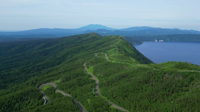 Hokkaido, Japan: Aerial drone footage of the panoramic road along lake Mashu in the Akan-Mashu NP in Hokkaido in summer in Japan. 