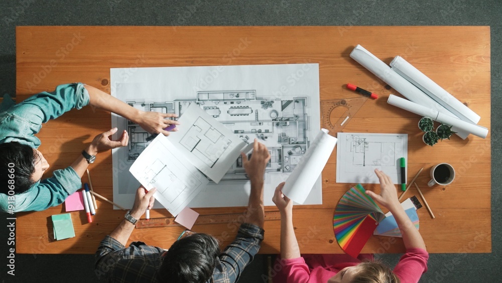 Poster group of people looking at blueprint while brainstorming idea. top view of engineer team looking and