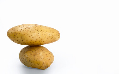 Stack of Raw potato on white background with copy space for banner, advertising, balance of gravity, science concept, food market, vegetable, vegan food