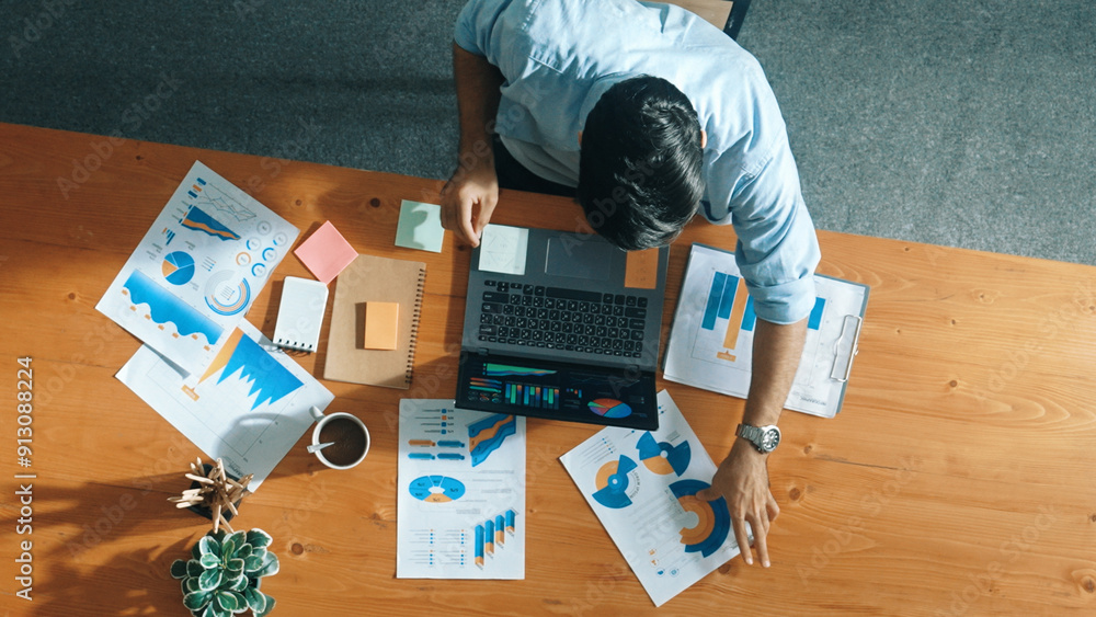 Poster top aerial view of manager working on laptop while looking at data analysis. leader compare financia