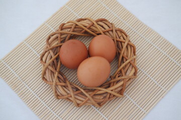 eggs on a bamboo mat on a white background