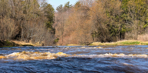   Smaller cascade on the river flowing through the forest