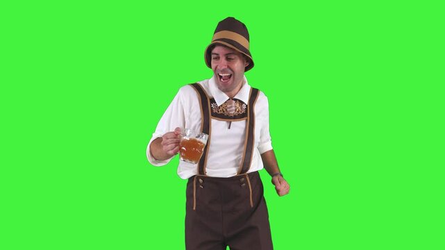 funny young bavarian man dancing joyfully with beer at oktoberfest chroma key
