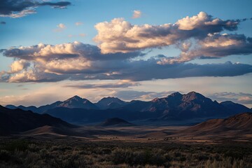 Fototapeta premium mountains at dusk, with large clouds in the sky