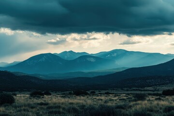 Obraz premium mountains at dusk, with large clouds in the sky