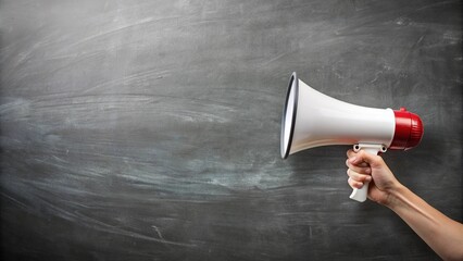 Hand with a megaphone in front of an empty blackboard
