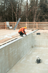 Dedicated Construction Worker Actively Engaged in the Comprehensive Pool Building Process