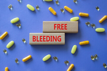 Free bleeding symbol. Concept words Free bleeding on wooden blocks. Beautiful purple background...