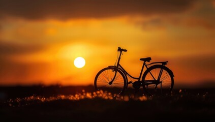 Obraz premium A silhouette of an old bicycle against the backdrop of sunset, with the sun setting in the background The bike is silhouetted against the sky and bathed in golden light Generative AI