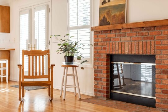 Brick Fireplace with Plant and Rocking Chair