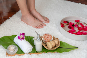 Woman indulges in blissful foot massage at luxurious spa salon while masseur give reflexology therapy in gentle day light ambiance resort or hotel foot spa. Quiescent