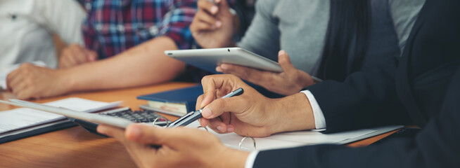 Discuss Corporate Team meeting, Executive Businessman and woman team plan work online with tablet on wooden office desk. Research Business and  Analyst summary report together in new project strategy.