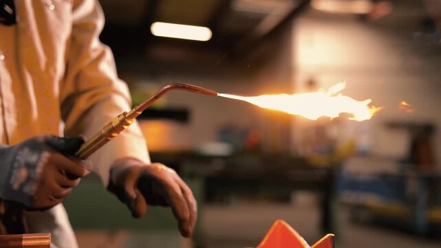 Pipefitter firing up an oxyacetylene torch for brazing