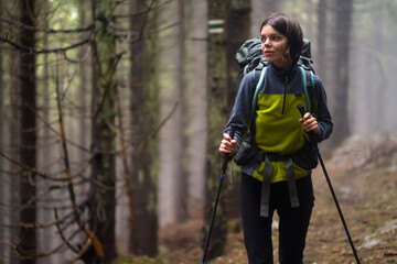 A young girl is engaged in active pastime, walks in the mountains along the trail, 