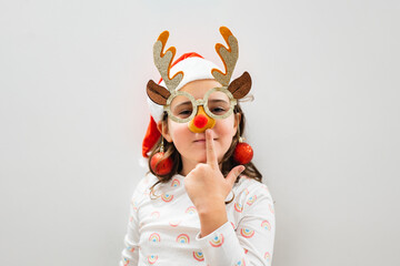 Child in reindeer glasses and Santa hat for Christmas