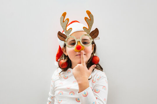 Child in reindeer glasses and Santa hat for Christmas