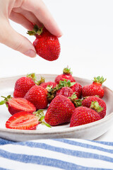 Hand Picking Fresh Strawberries From Plate