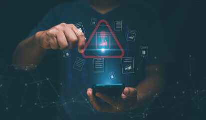 Online data security concept. Man using smartphone and holding magnifying glass with caution warning sign and file warning alert on virtual screen. Hacker attacks. Detection dangerous worms.