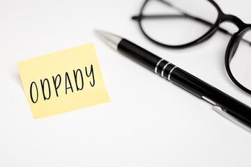 A yellow sticky note on a white background with the handwritten inscription 