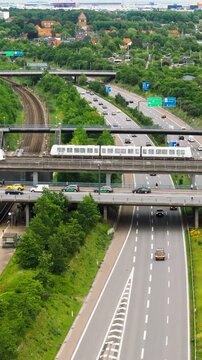 Aerial drone view of the European route E20 on a cloudy day. Vertical