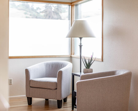 Two chairs by window