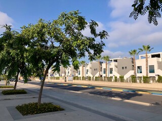Fototapeta premium Street view of asphalt road in front of modern urban houses condominium