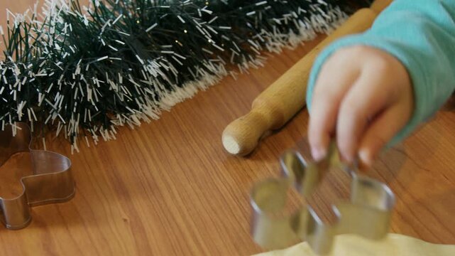 Cute child little elf making christmas ginger bread cookies. High quality 4k footage