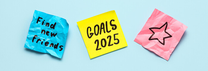 Sticky notes with different goals for 2024 on blue background