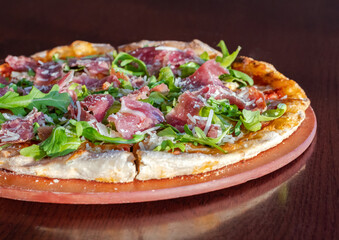 Pizza with prosciutto arugula and parmesan 