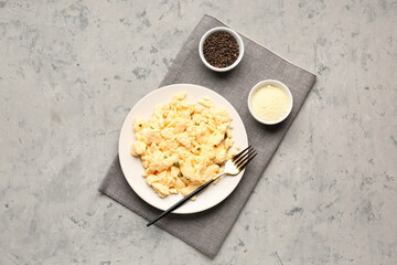 Composition with plate of scrambled eggs on grunge background