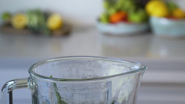VEGETABLES falling into a blender in slow motion

