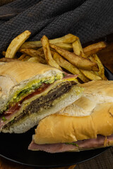 Milanese sandwich with fries, mayo, egg, ham and cheese, tomato and lettuce, French bread