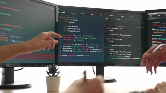 Slow motion back end software developer engineer for computer programming working together on debugging writing computing code, solving complex algorithms display on monitor in office. Burgeoning