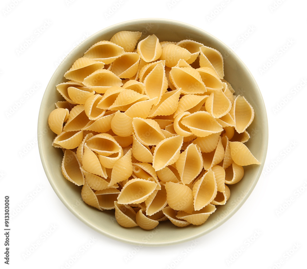 Wall mural bowl with tasty raw conchiglioni pasta on white background