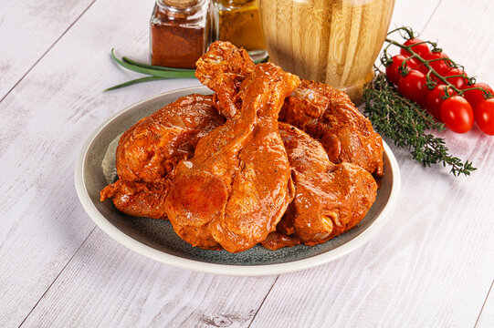 Raw turkey shoulder wing in Indian tandoori marinade