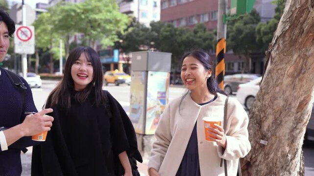Taiwanese man and woman in their 20s and a South Asian woman having a friendly chat at an intersection near a university in Da&rsquo;an District, Taipei City, Taiwan.&nbsp;