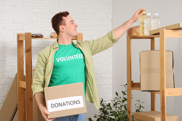 Male volunteer with donations in center