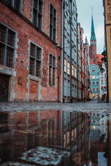 A street view in Gdansk, Poland, colorful buildings and a church 