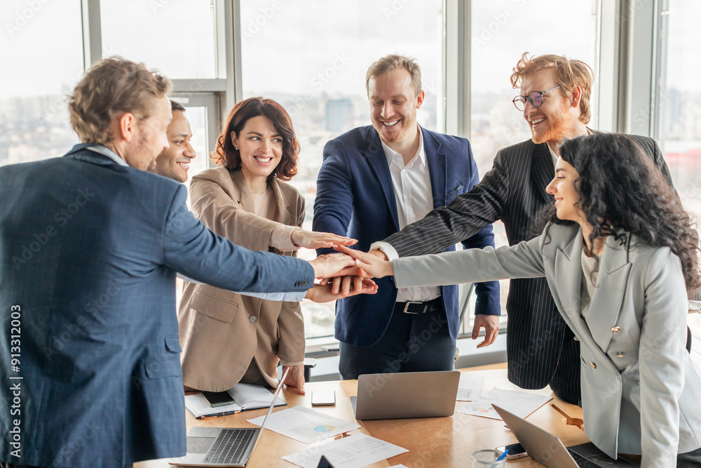 Aufkleber a diverse business team of six people stand around a table with laptops and paperwork in a modern of