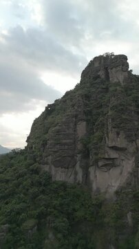 Vertical drone video. Rock formations, forested mountains and large formations. Hiking through the green forest. Hiking concept. Amatlan, Mexico