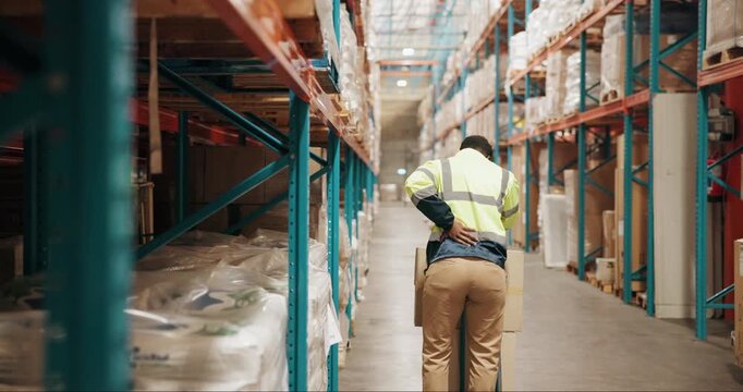 Warehouse, shipping and man with back pain, burnout and overworked with distribution deadline. Person, supply chain and employee with joint injury, muscle tension and logistics with pressure on spine
