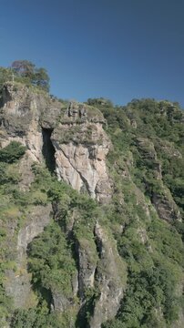 Vertical drone video. Rock formations, forested mountains and large formations. Hiking through the green forest. Hiking concept. Amatlan, Mexico