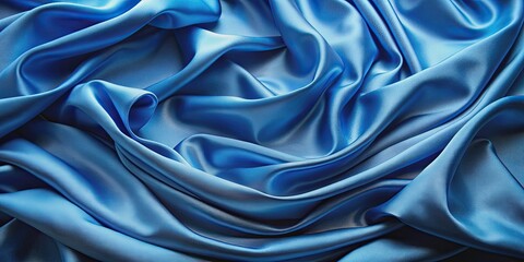 Fototapeta premium Close-up of flowing blue fabric showing texture and graceful folds, blue, fabric, flowing, texture, graceful, folds