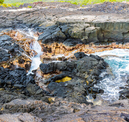 Water Rushing Over The Lava SInks and Cliffs at Hokulia Shoreline Park, Hawaii Island, Hawaii, USA