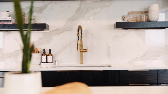 orbiting shot of a luxury golf faucet in a kitchen with white and black accents