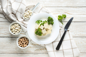 Tofu in a bowl with beans on a white background